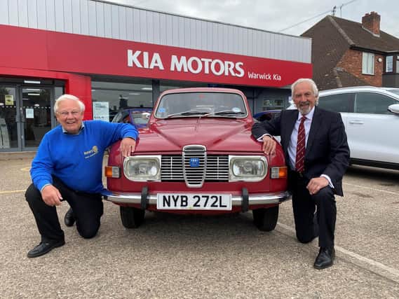 Barry Andrews (left) from Leamington Rotary Club with Kia Warwick managing director David Derbyshire and his classic 1975 Saab 95.