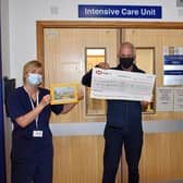 Alan Jennings presents the cheque for £2,000 to staff at Warwick Hospital's intensive care unit.