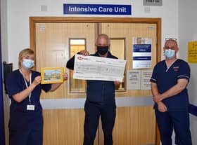 Alan Jennings presents the cheque for £2,000 to staff at Warwick Hospital's intensive care unit.