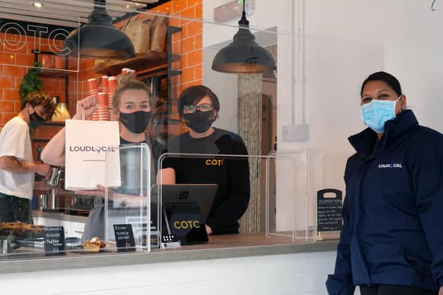 Priya Pandit of LoudLocal hands out one of the company's goodie bags to staff at Coffee on the Corner in Kenilworth.