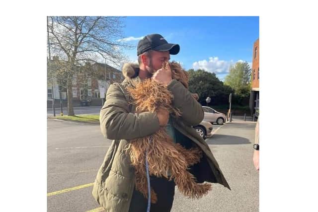 Blossom, a Cockapoo, is reunited with her owners at Rugby Police Station.