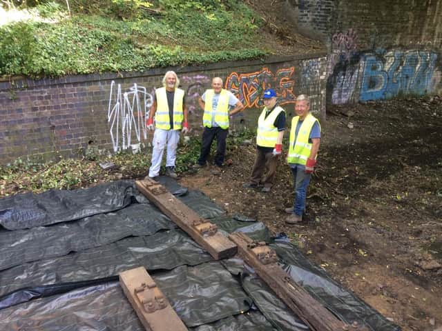 Volunteers laying track last year.