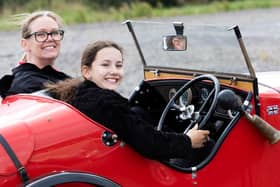 A youngster gets behind the wheel of a stunning Austin 7 Ulster replica.