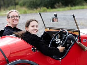 A youngster gets behind the wheel of a stunning Austin 7 Ulster replica.