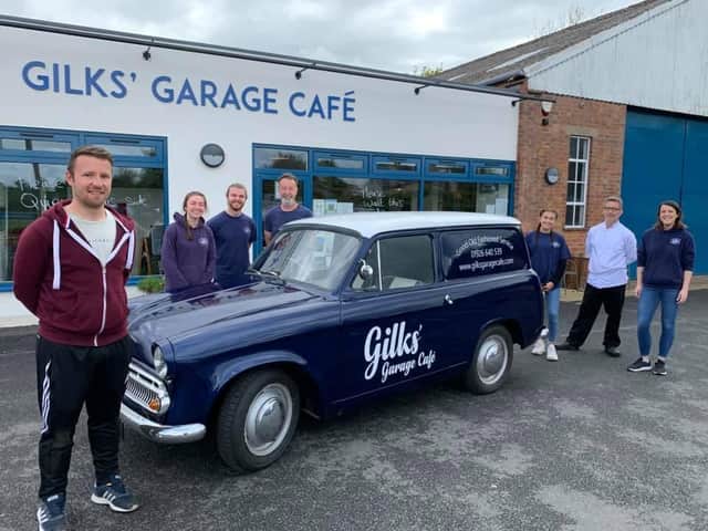 The Gilks' Garage Cafe staff and Cameron Mair from C.M. Signs stand around the cafe's new delivery van affectionately known as 'Cobby' - officially a 1961 Commer Cob.