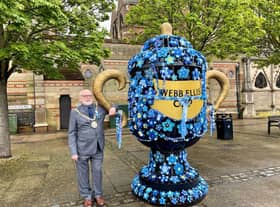 Rugby mayor Cllr Bill Lewis next to the yarn-bombed cup. Photo courtesy of Karen Handley.