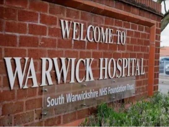 Two men have been accused of assaulting and racially abusing workers at Warwick Hospital.