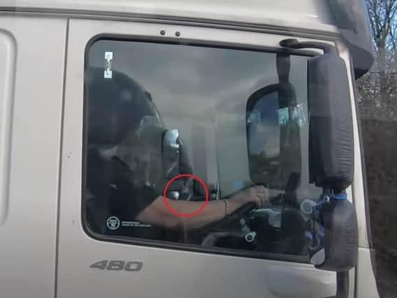 This driver was caught on film texting on his phone while driving.