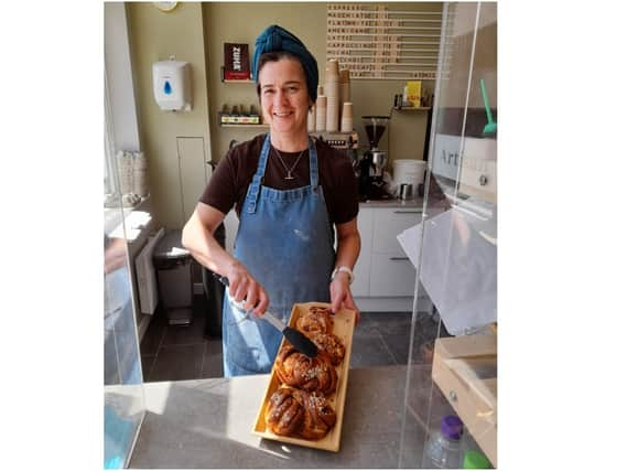 Sarah Thornber, the owner of Corner Cottage Bakery, holds a tray of Kanelbullar cinnamon rolls