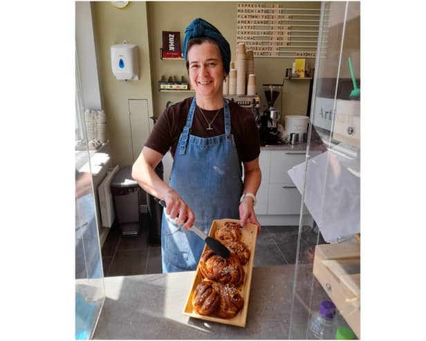 Sarah Thornber, the owner of Corner Cottage Bakery, holds a tray of Kanelbullar cinnamon rolls