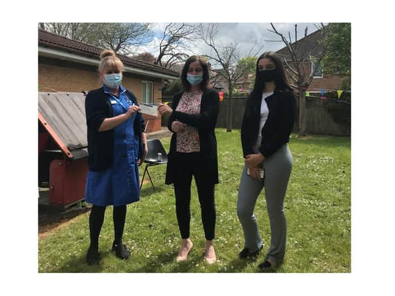 Community nurse Emma Hutchinson (left) accepts the cheque from Helen Gardner (centre) and daughter Zoe (right).