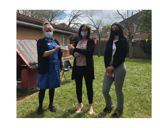 Community nurse Emma Hutchinson (left) accepts the cheque from Helen Gardner (centre) and daughter Zoe (right).