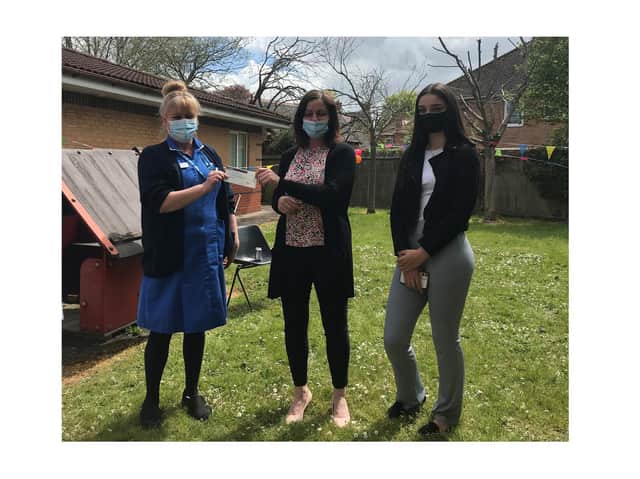 Community nurse Emma Hutchinson (left) accepts the cheque from Helen Gardner (centre) and daughter Zoe (right).