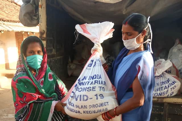 A woman from Odisha state receiving an emergency food parcel. Photo supplied