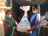 A woman from Odisha state receiving an emergency food parcel. Photo supplied
