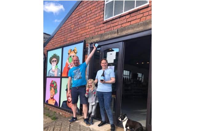 Jolyon, Charlotte and Matilda Olivier with the Taproom Special cider and Smudge the dog. Photo supplied