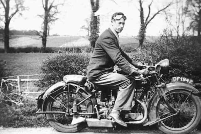 John enjoys an AJS motorbike in his younger years.