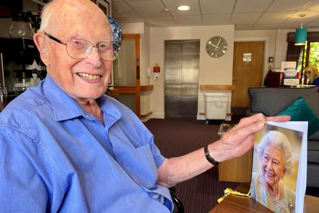 John with his card from the Queen.