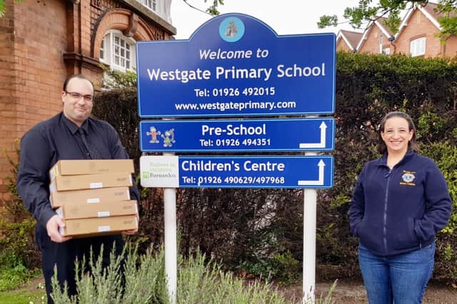 Warwick Lion Tamara Friedrich presents laptops to Westgate Primary School. Photo supplied