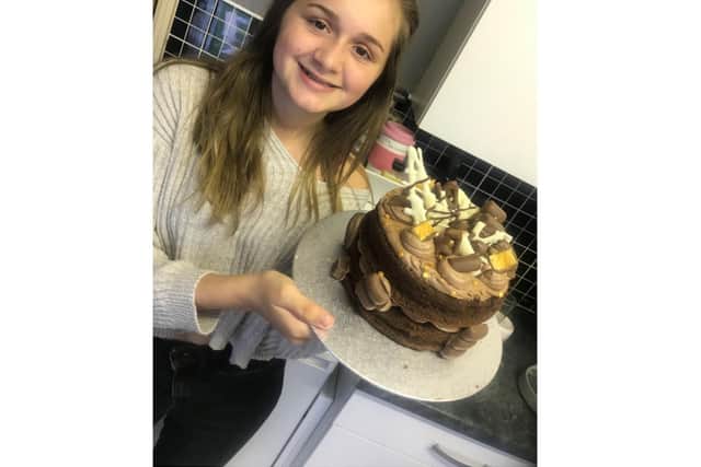 Charlie with one of her cakes. Photo supplied