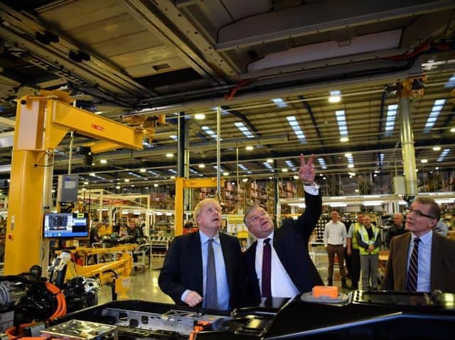 MP Mark Pawsey (right) with the Prime Minister Boris Johnson MP (left) and Joerg Hofmann, CEO of the London Electric Vehicle Company (centre) at the LEVC’s factory at Ansty Park in Rugby.