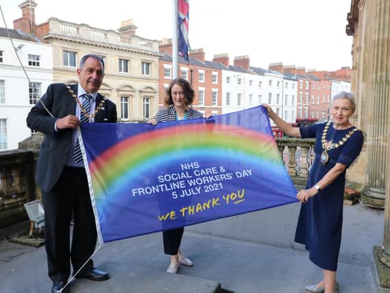 Warwick District Council chairman Cllr Neale Murphy, Anne Coyle (managing director of South Warwickshire NHS Foundation Trust) and the Mayor of Leamington, Cllr Susan Rasmussen with the thank you flag.