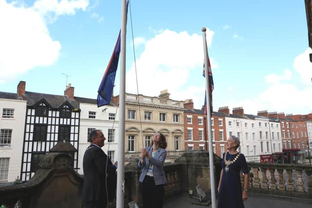 Anne Coyle (managing director of South Warwickshire NHS Foundation Trust) lifts up the flag, alongside Mayor of Leamington, Cllr Susan Rasmussen and Warwick District Council chairman Cllr Neale Murphy.