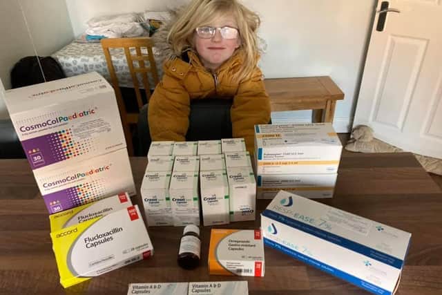 Chloe with the medication she has to take for cystic fibrosis.