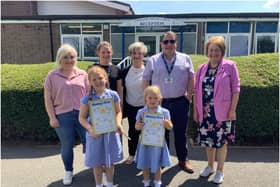Sophia and Florence Halford. They are photographed with their mum, class teacher Miss Fletcher, their grandmother, dad and Rotarian Margaret Morley. Photo supplied