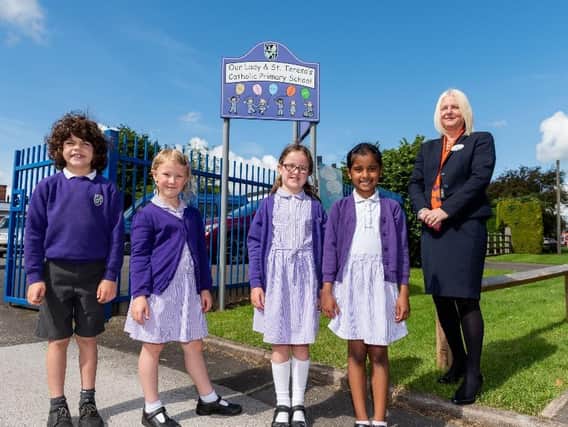 Pupils of Our Lady and St Teresa’s Catholic Primary School with Bellway sales advisor Tina Yates.