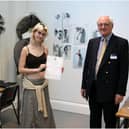Hannah Smith (centre) with her award certificate. Photo supplied