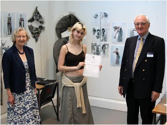 Hannah Smith (centre) with her award certificate. Photo supplied