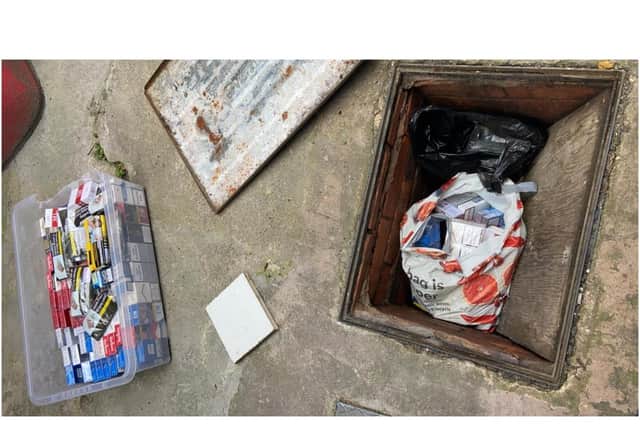 Thousands of illegal cigarettes and tobacco were discovered below a manhole cover, suspended above raw sewerage at the rear of a shop in Leamington. Photo supplied
