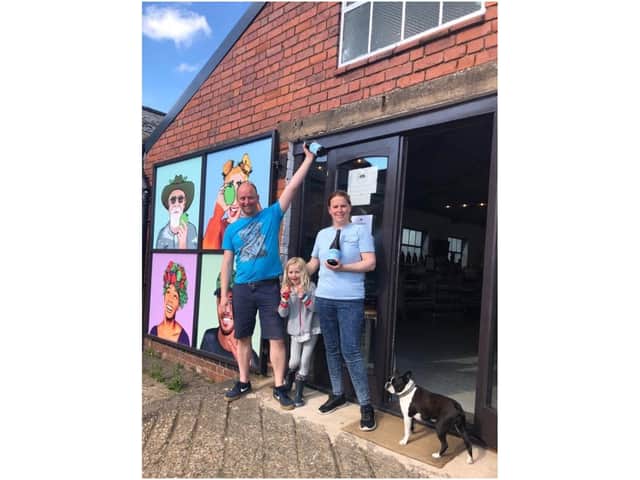 Jolyon, Charlotte and Matilda Olivier with the Taproom Special cider and Smudge the dog. Photo supplied