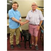 Past President David Brain hands a donation to Martyn Parker (and Wheeler) from Guide Dogs. Photo supplied