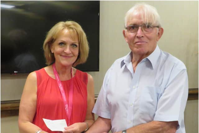 Past President David Brain hands a donation to Jackie Evans of Molly Olly’s Wishes. Photo supplied