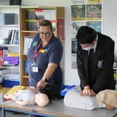 Nurse Anneke shows Avon Valley pupil Tom McGee how to perform CPR.