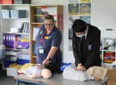 Nurse Anneke shows Avon Valley pupil Tom McGee how to perform CPR.