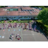 Aerial photo with Reception to Year 2 classes BH1-BH9 formed a letter each and all staff stood behind. Photo supplied