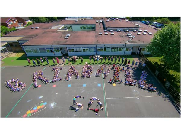 Aerial photo with Reception to Year 2 classes BH1-BH9 formed a letter each and all staff stood behind. Photo supplied