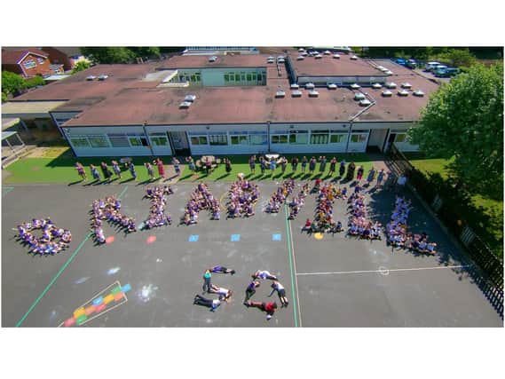 Aerial photo with Reception to Year 2 classes BH1-BH9 formed a letter each and all staff stood behind. Photo supplied