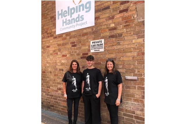 Joshua Gallion (centre) with Lianne Kirkman, CEO and founder of Helping Hands Community Project (right) and Shan, operations manager (left). Photo supplied