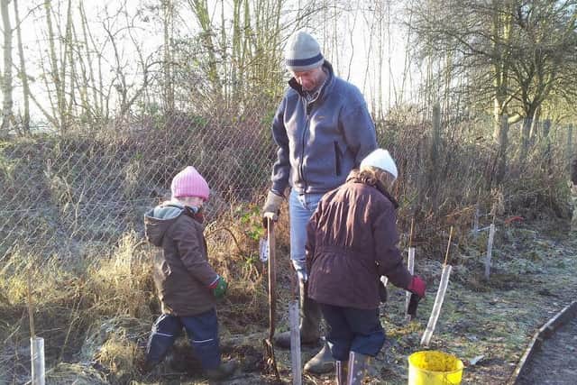 Children helping to plant trees at Foundry Wood. Photo supplied by Warwickshire County Council