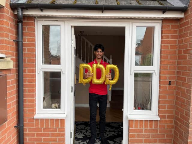 Anoop Bains celebrates a clean sweep of three Distinction* grades.