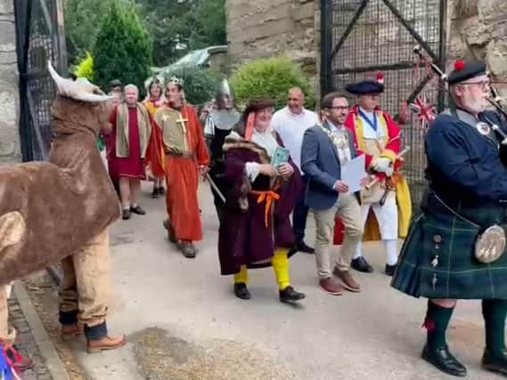 The Mayor of Warwick, Cllr Richard Edgington, accompanied by the Town
Crier and Chris Willsmore, Chairman of the Guy of Warwick Society, flanked by 'The Dun Cow', taking part in a costumed procession at the start of Guy of Warwick Day at Guys Cliffe House. Photo supplied
