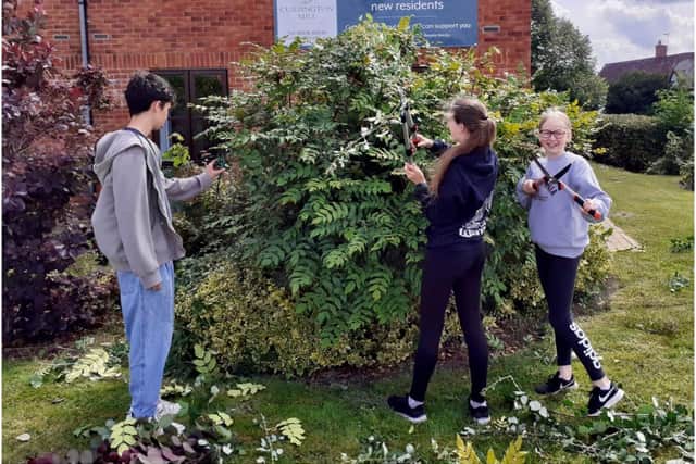 Members of the NCS team trimming in the garden. Photo supplied