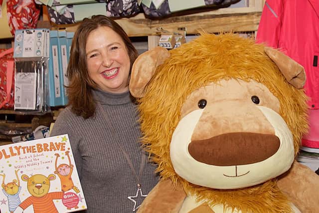 Rachel Ollerenshaw of Molly Olly's Wishes with the charity's mascot Olly The Brave and a story book about the character.