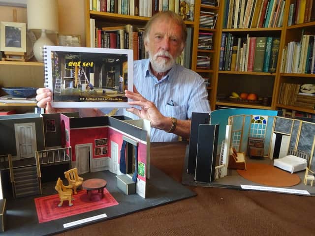 Designer John Ellam with models of two stage sets featured in the new book.