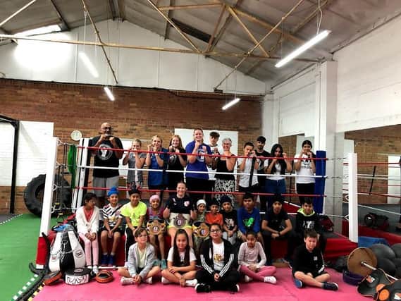 Morgan Ansell (centre wearing black t-shirt and belt) with boxers and coaches at Leamington Community Boxing Club.