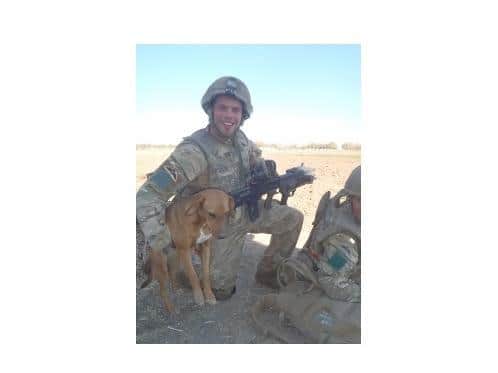 Private Conrad Lewis with his dog Pegasus in Afghanistan.